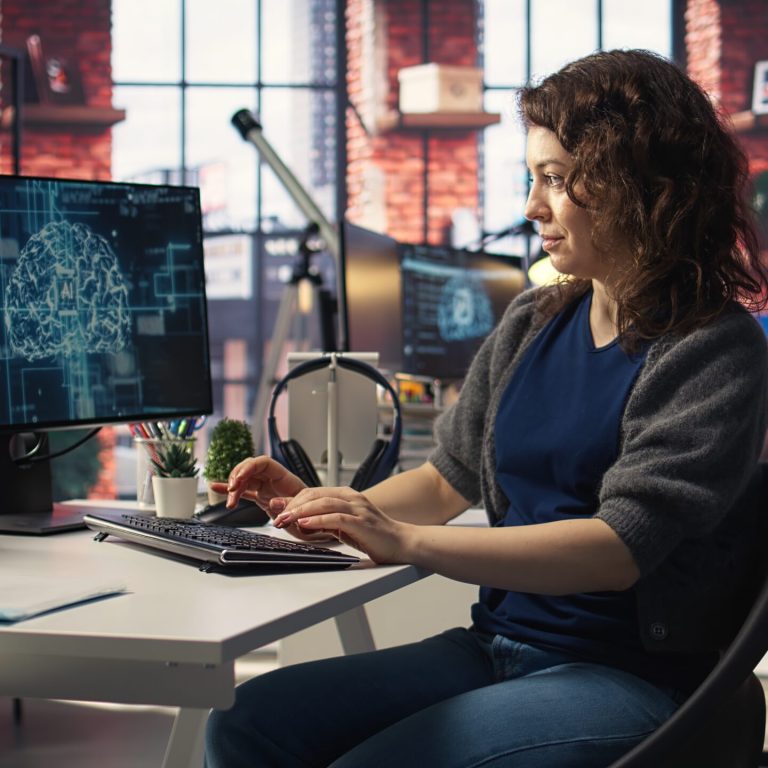 Teleworking developer using computer for artificial intelligence computing through self learning algorithms. Agency IT engineer works with AI deep neural networks on desktop PC. Camera A.